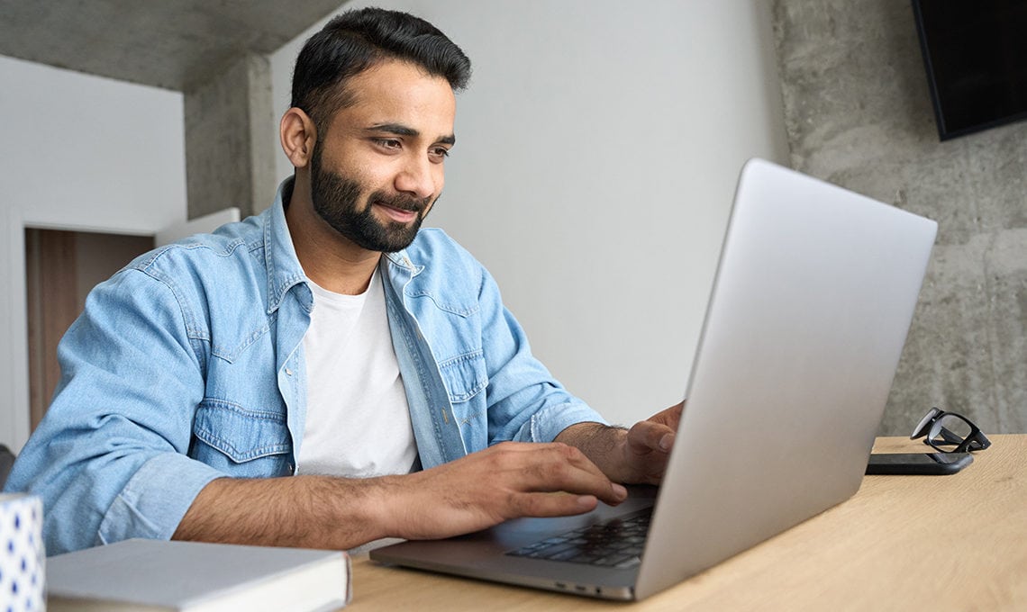 Indian man studying online